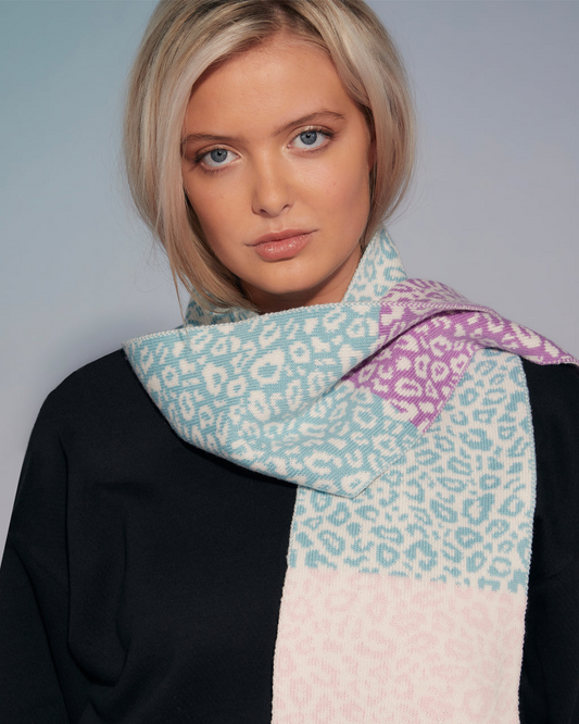 Woman wearing a Leopard Block Colour Wool & Cashmere Scarf - Pastel, Sustainable on a plain background