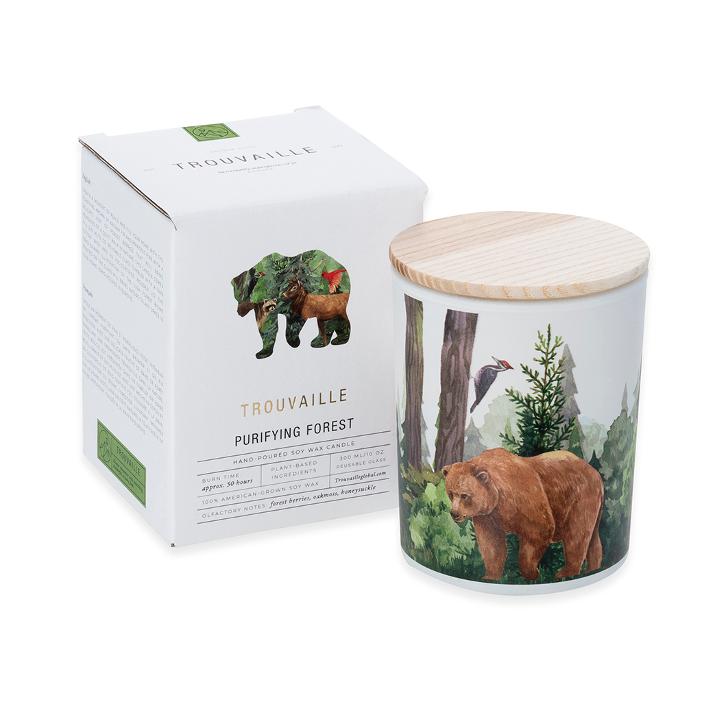 Candle with bear design and packaging labeled 'Trouvaille' on a white background