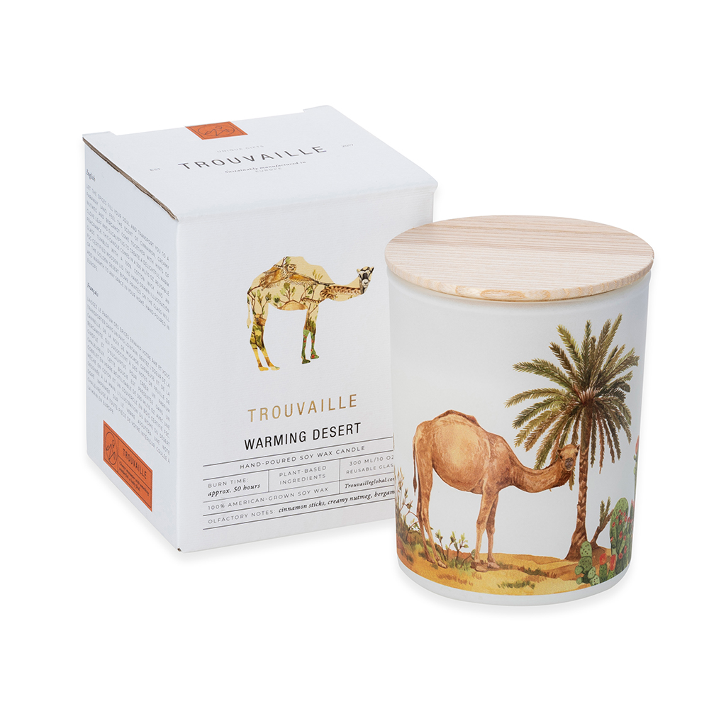 Candle with desert design and packaging featuring a camel and palm tree on a white background