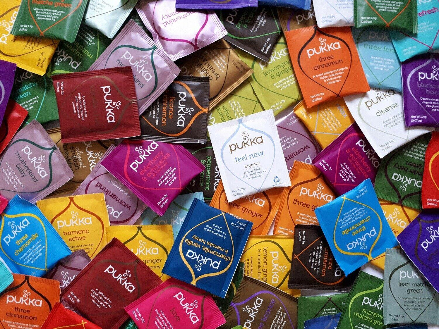 Assorted Pukka tea packets in various colors and designs.
