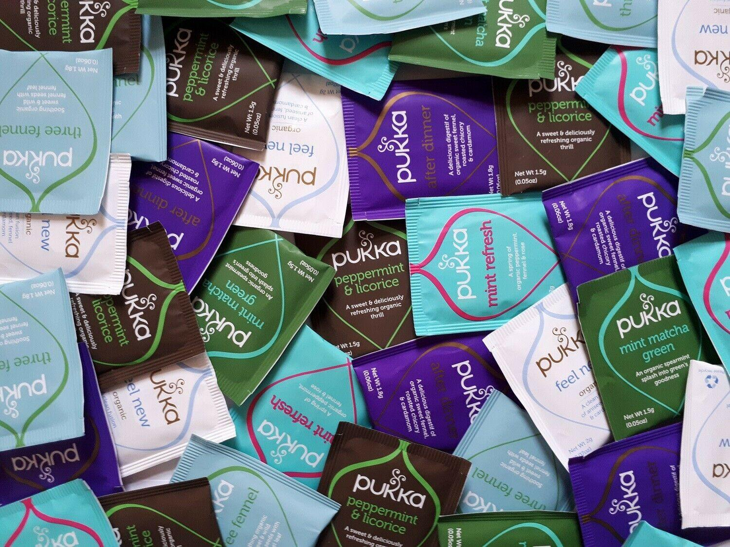 Collection of various Pukka tea packets in different colors and flavors.
