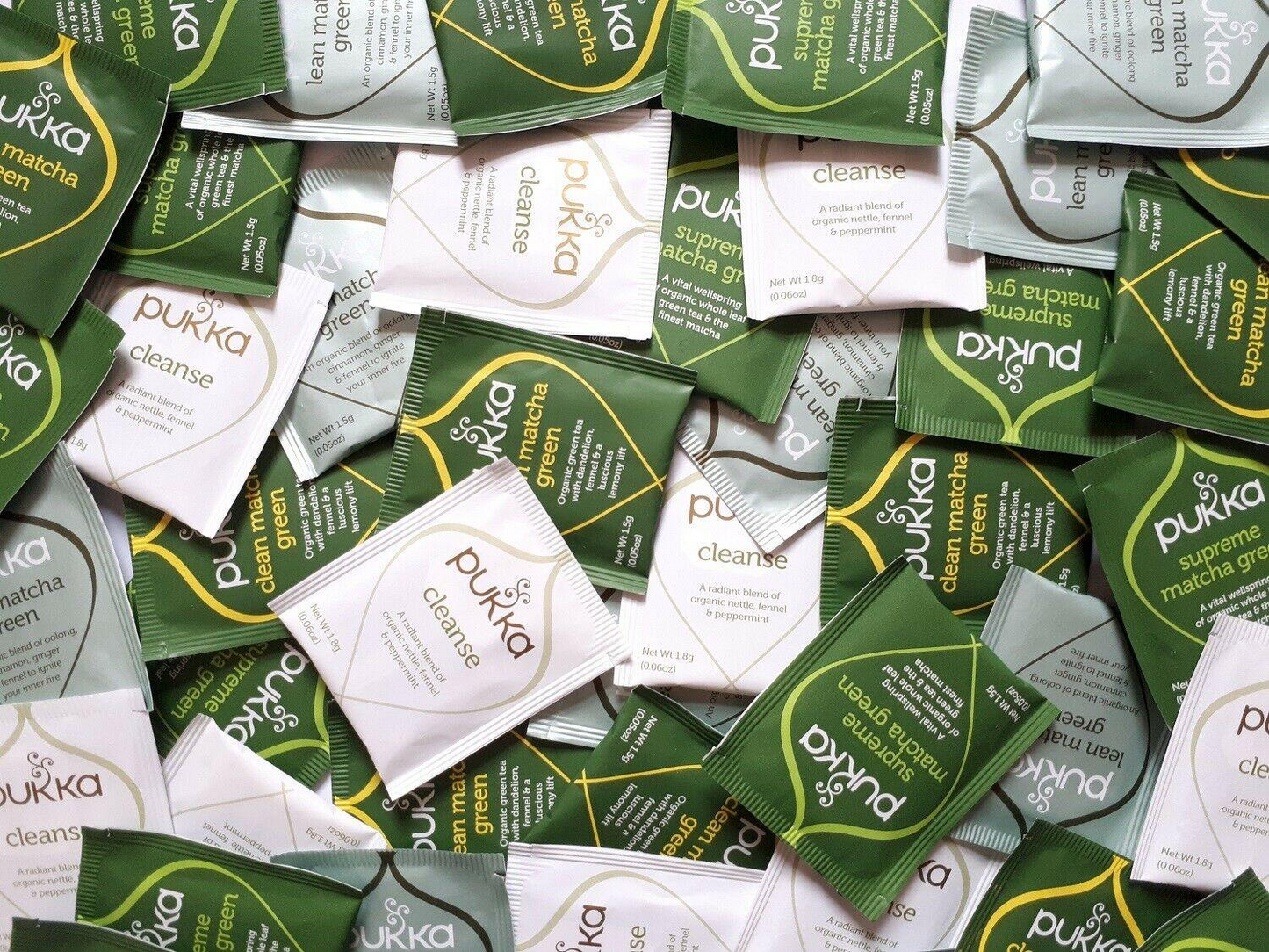 Pile of Pukka tea packaging in various flavors.