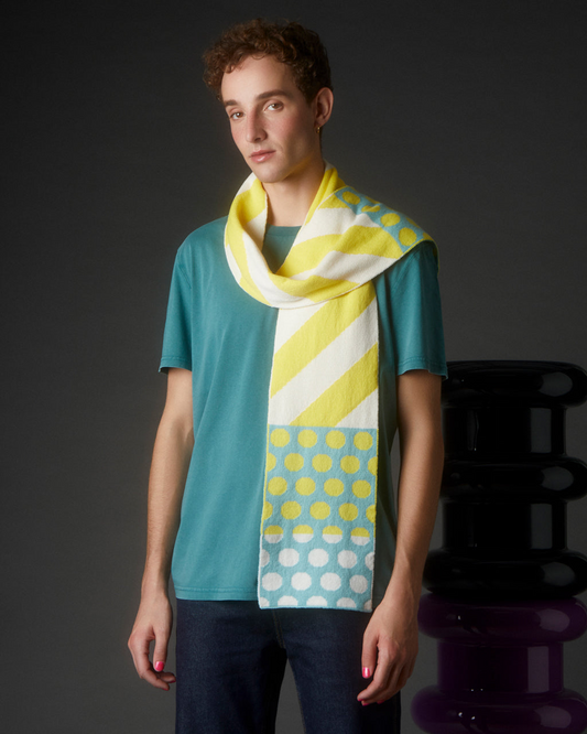 Person wearing a Stripes & Circles Yellow Wool & Cashmere Scarf - Sustainable, Ethical, Luxurious on a dark background