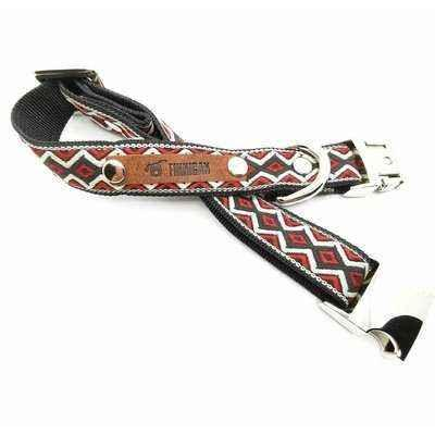 Dog collar with patterned strap and metal buckle on a white background