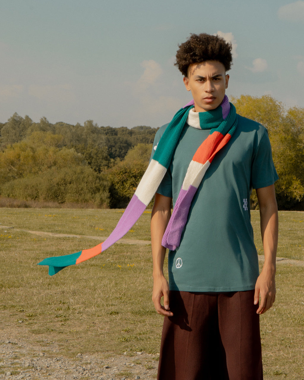 Person wearing a Luxurious Ribbed Wool & Cashmere Colour-Block Scarf - Lilac & Teal | Ethical & Made in London in an outdoor setting