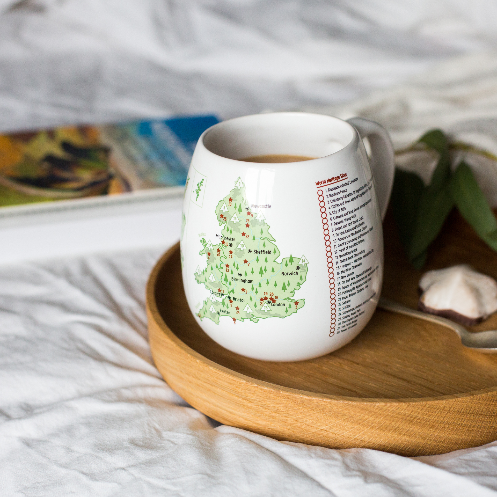 White mug with a UK (England) map design on a wooden tray with a blurred background