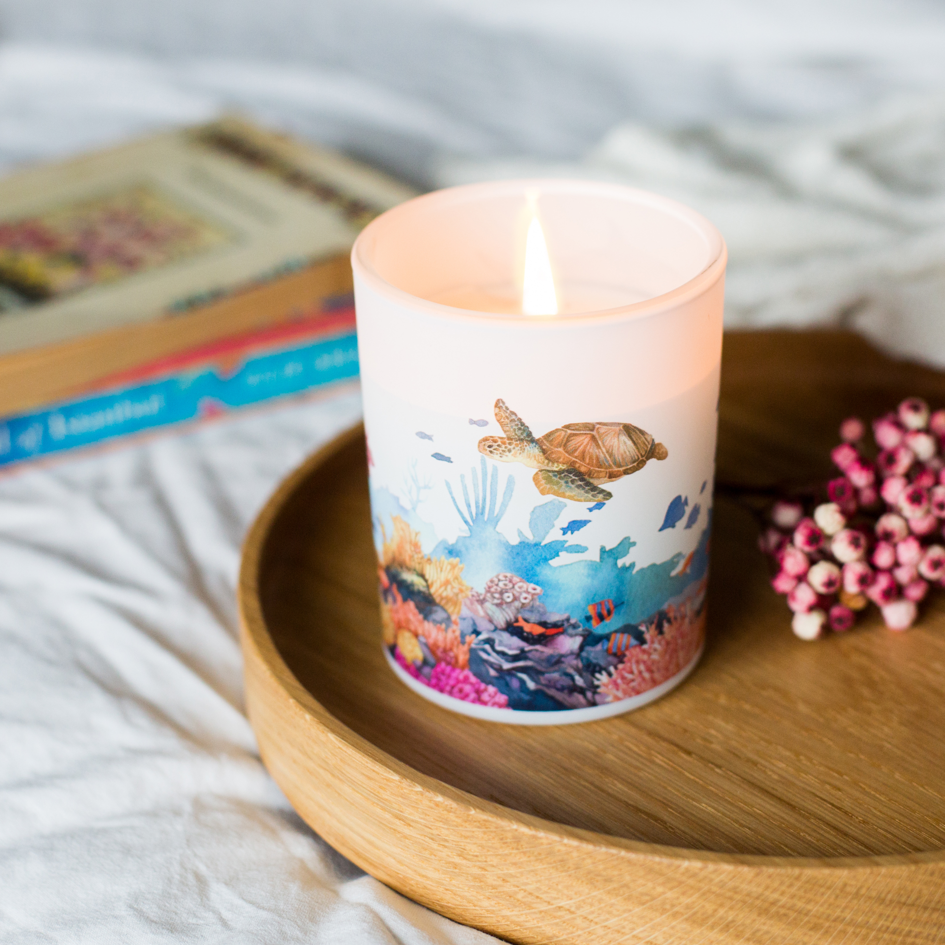 Candle with an underwater scene design on a wooden tray