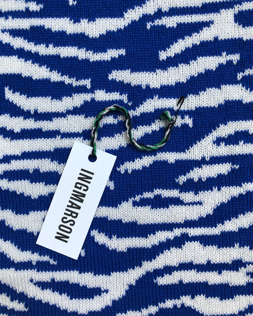 Blue and white patterned fabric with a 'Ingmarson' tag.