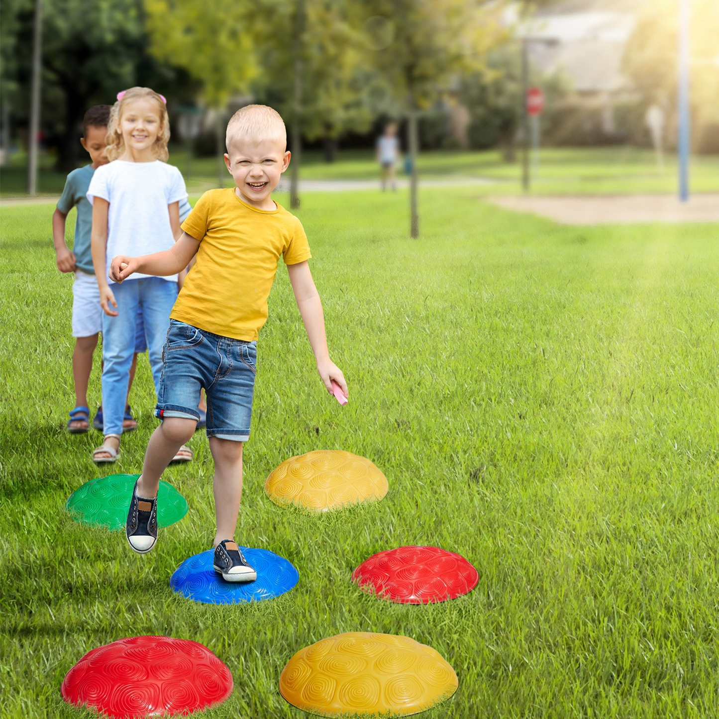 Children playing on colorful stepping stones in a park