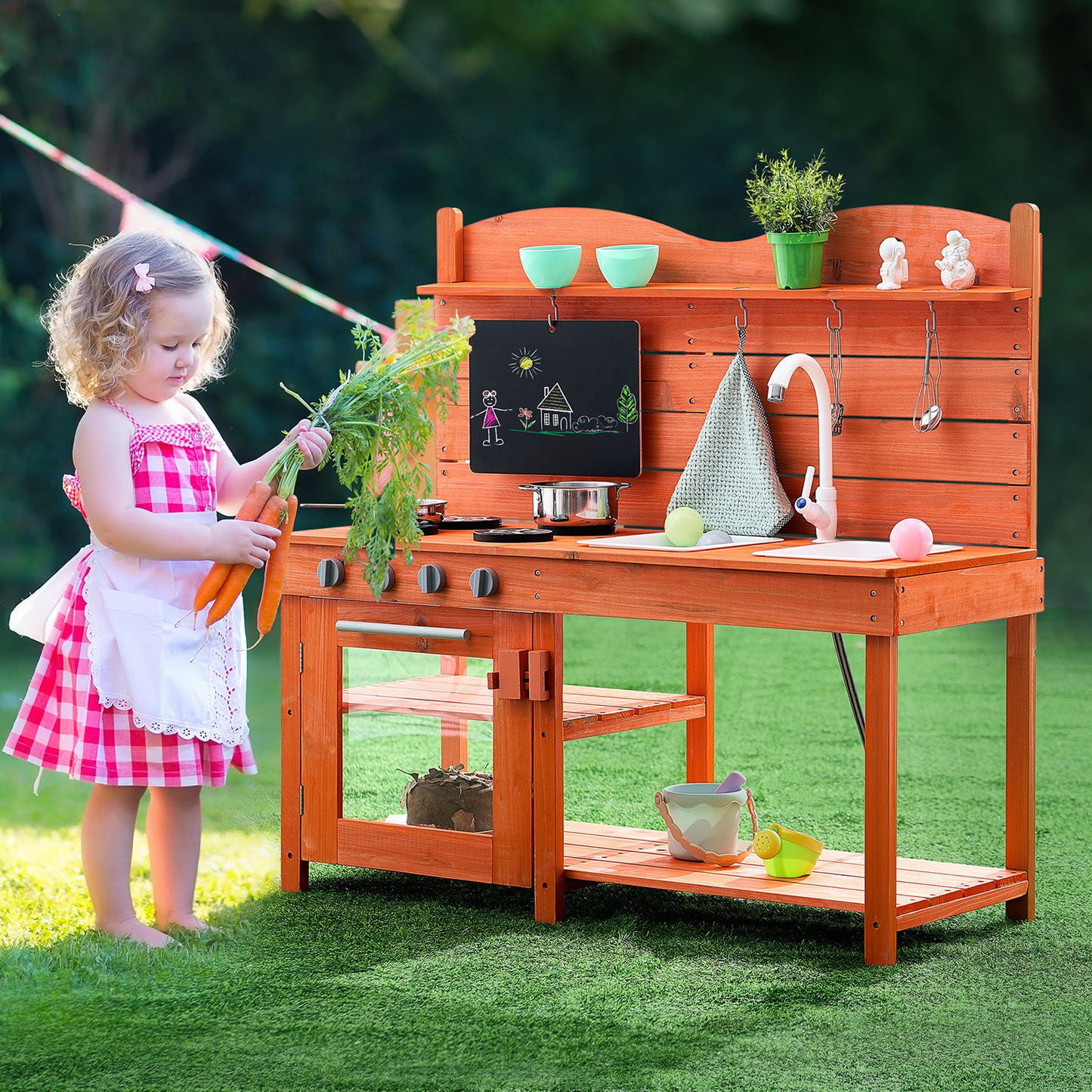 Child playing with a wooden play kitchen set outdoors